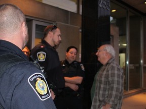 Sarnia police officers remove a citizen from city hall after he continued to heckle city council Monday night. Council voted to temporarily relocate Sarnia Mayor Mike Bradley's office from city hall during an emotionally-charged meeting. Barbara Simpson/Sarnia Observer/Postmedia Network