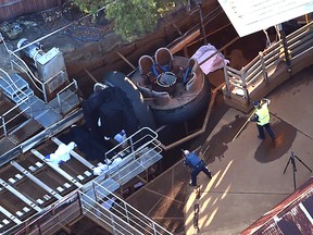 Queensland Emergency Services personnel are seen at the Thunder River Rapids ride at Dreamworld on the Gold Coast, Australia, Tuesday, Oct. 25, 2016. Four people died after a malfunction caused two people to be ejected from their raft, while two others were caught inside the ride at the popular theme park. (Dan Peled/AAP via AP)