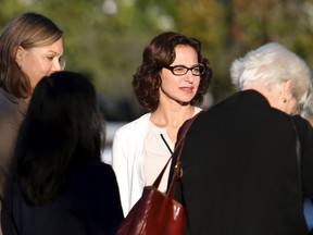 Sabrina Erdely, centre, enters the federal courthouse in Charlottesville, Va., on Monday, Oct. 17, 2016. Erdely, author of "A Rape on Campus," a discredited Rolling Stone article detailing an alleged rape at the University of Virginia, is being sued by Nicole Eramo, a UVa administrator included in the story. (Ryan M. Kelly/The Daily Progress via AP)