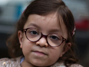 In this Thursday, Oct. 20, 2016 photo, Maria, who is suffering from a disease known as Morquio Syndrome, poses for a picture in Rawalpindi, Pakistan. The U.S. embassy in Islamabad issued a last minute visa to Maria, an ailing 6-year-old Pakistani child, afflicted with a painful genetic disorder, and her parents who turned to the media as the date for their child’s life altering operation in the United States loomed. (AP Photo/B.K. Bangash)