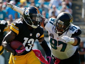 Roy Miller of the Jacksonville Jaguars attempts to tackle Dri Archer of the Pittsburgh Steelers during the game at EverBank Field on October 5, 2014 in Jacksonville, Florida. (Sam Greenwood/Getty Images)