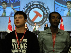 Protesters turn their backs on Prime Minister Justin Trudeau as he addresses the Canadian Labour Congress National Young Workers’ Summit in Ottawa on Tuesday October 25, 2016. (THE CANADIAN PRESS/Fred Chartrand)