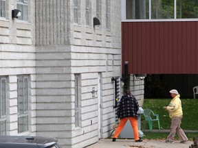 Staff members walk into the Caressant Care facility in Woodstock, Ontario on Tuesday, Oct. 25, 2016. Police in southwestern Ontario say between 2007 and 2014, a nurse administered a drug and killed eight nursing home residents in her care. (THE CANADIAN PRESS/Dave Chidley)