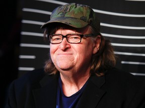 In this May 16, 2016 file photo, Michael Moore attends the 20th Annual Webby Awards at Cipriani Wall Street in New York. Moore premiered a surprise film about the U.S. presidential election on Tuesday, Oct. 18, 2016. "Michael Moore in TrumpLand" features a one-man stage show of Moore discussing the race. (Photo by Andy Kropa/Invision/AP, File)