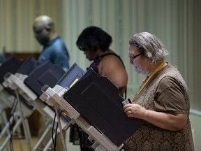 Voters cast electronic ballots during primary voting in Stark County March 15, 2016 in Canton, Ohio.  (BRENDAN SMIALOWSKI/AFP/Getty Images)
