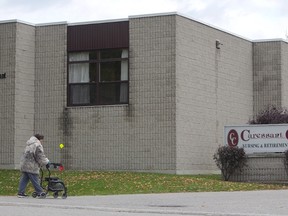 A woman walks into the Caressant Care facility in Woodstock, Ontario on Tuesday, Oct. 25, 2016. (THE CANADIAN PRESS/Dave Chidley)