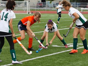 Bayridge Blazers’ Maria Amsden battles with Holy Cross Crusaders’ Caleigh Patterson for possession of the ball during a Kingston Area Secondary Schools Athletic Associations girls field hockey game at CaraCo Field on Oct. 4. (Julia McKay/The Whig-Standard)