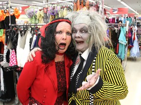 Value Village employees Christine Dunley, left, and Debbie Robson dress as characters from Beetlejuice as they help customers find costumes for Halloween in Kingston on Monday. People can buy off the rack or create their own costumes from used clothing. (Michael Lea/The Whig-Standard)