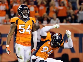 Broncos' DeMarcus Ware (94), seen here with teammate Brandon Marshall (54), said his home was burglarized during Monday nights game against the Texans in Denver. (Jack Dempsey/AP Photo/Files)