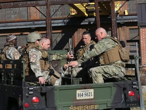 Roanoke Sheriff's Office SWAT team, along with several agencies, responded to a fatal shooting at FreightCar America in Roanoke, Va., Tuesday morning, Oct. 25, 2016. Police say a man fatally shot someone and wounded several others inside the rail car manufacturing company in Virginia before apparently killing himself. (Heather Rousseau/The Roanoke Times via AP)
