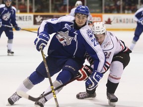 Sudbury Wolves defenceman Kyle Capobianco, left, muscles his way past the Owen Sound Attack's Justin Brack during Ontario Hockey League action at the Lumley Bayshore in Owen Sound, Ont. on Dec. 6, 2015. Capobianco was named to Team OHL on Tuesday. James Masters/Postmedia