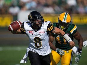 Eskimos' Odell Willis (41) chases Tiger-Cats QB Jeremiah Masoli (8) during first half CFL action at Commonwealth Stadium in Edmonton on Saturday, July 23, 2016. (Greg Southam/Postmedia)