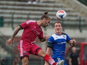 FC Edmonton captain Albert Watson goes up for the ball against an Ottawa Fury player earlier this season. (Shaughn Butts)