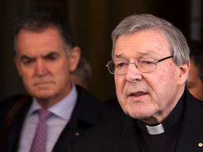 FILE - In this March 3, 2016 file photo, Australian cardinal George Pell reads a statement to reporters as he leaves the Quirinale hotel after meeting members of the Australian group of relatives and victims of priestly sex abuses, in Rome, Italy. Australian police flew to Rome to interview a top Vatican cardinal about allegations of sexual assault dating back decades, officials said Wednesday, Oct. 26, 2016. Cardinal George Pell, Pope Francis' top financial adviser, has long been dogged by allegations of mishandling cases of clergy abuse when he was archbishop of Melbourne and later Sydney.(AP Photo/Riccardo De Luca, File)