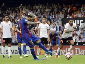FC Barcelona's Lionel Messi kicks for the ball to score a penalty during the Spanish La Liga soccer match between Valencia and FC Barcelona at the Mestalla stadium in Valencia, Spain, Saturday, Oct. 22, 2016. (AP Photo/Manu Fernandez)