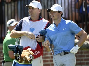 Rory McIlroy of Northern Ireland, right, and his caddy, J. P. Fitzgerald look down the fairway before McIlroy tees off from the first hole during the final round of The Barclays golf tournament in Farmingdale, N.Y.. (AP Photo/Kathy Kmonicek)