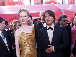 Nicole Kidman, wearing a Dior gold dress with gold antique gloves, is pictured with then-husband Tom Cruise at the Oscars. (WENN.COM file photo)