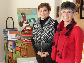 Janice Barling, left, and Deb Ruse, members of the Grandmothers Connection, stand next to some of the items that will be for sale in a fundraising event that will support grandmothers in Africa. (Michael Lea/The Whig-Standard)