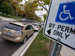 A sign on a post identifies this Dufferin Avenue parking spot, near the corner of Richmond Street, is for drivers with a disability permit. (CRAIG GLOVER, The London Free Press)