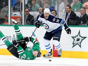 Esa Lindell #23 of the Dallas Stars passes the puck against Shawn Matthias #16 of the Winnipeg Jets at American Airlines Center on October 25, 2016 in Dallas, Texas.
