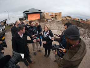 Premier Rachel Notley speaks with media outside of a home under construction in the subdivision of Wood Buffalo in Fort McMurray Alta. on Wednesday October 26, 2016. Notley toured the region ahead of the six-month anniversary since the region was evacuated due to wildfires May 3. Robert Murray/Postmedia Network