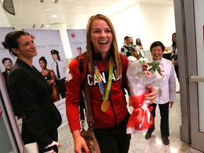 Erica Wiebe reacted to the welcoming crowd on her arrival at Pearson International Airport in Toronto after winning gold in wrestling at the Rio Olympics. (Michael Peake)