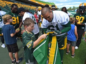 Joel Figueroa, shown here signing memorabilia for fans in July, got his first start of the season last week against the B.C. Lions. (Ed Kaiser)