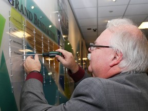 Tim Miller/The Intelligencer
Intelligencer Advertising Director Gerry Drage adds a plaque to the Partners in Health Care recognition wall in the lobby of the Sills Wing of Belleville General Hospital on Wednesday. The Intelligencer was one of four Grand Benefactors recognized at a donor appreciation night put on by the BGH Foundation.