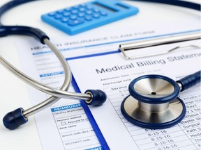 Stethoscope on medical bills and health insurance claim form. (Getty Images/iStockphoto)