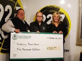 Dan Xilon, left, executive director of the Sudbury Food Bank, Kevin McCormick, president and vice-chancellor of Huntington University, and Mellaney Dahl, morning show host of 92.7 Rock and president of the Sudbury Food Bank, take part in a donation presentation. Supplied photo