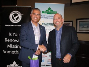 OHBA President Neil Rodgers congratulates newly sworn in DRHBA President Ken Russell at the not-for-profit association’s Annual General Meeting October 18 at Deer Creek Golf & Banquet Facility.