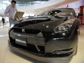 A visitor looks at Nissan GT-R at the showroom in its headquarters in Yokohama, on May 12, 2010. (TOSHIFUMI KITAMURA/AFP/Getty Images)
