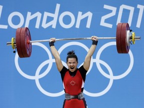 Christine Girard of Canada competes during the women's 63-kg, group A, weightlifting competition at the 2012 Summer Olympics, Tuesday, July 31, 2012, in London. Girard won the bronze medal. (AP Photo/Hassan Ammar)