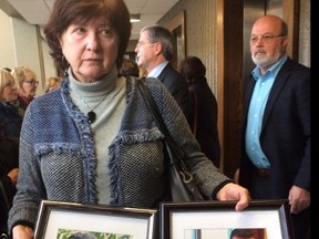 Terry Miller hold pictures of her children Catie Miller and Christopher Miller in Halifax on Thursday Oct. 27, 2016.  THE CANADIAN PRESS/Michael Tutton