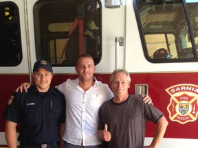 Sarnia firefighter Jim Rose, left, is pictured with Sarnia man Matt Gordon, and Amherstburg man Mike Grimard. Grimard was rescued by Rose and Gordon after his boat capsized in September. Sarnia Mayor Mike Bradley is suggesting the city establish a bravery award for citizens like Gordon, who risk their lives to help others. (Submitted)