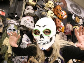 Julie Jacques a sales associate at Spirit Halloween on Notre Dame Ave. dons a mask in Sudbury, Ont. on Thursday October 27, 2016. The forecast for Halloween Monday calls for a high of 7 with a chance of showers.Gino Donato/Sudbury Star/Postmedia Network