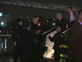 Republican presidential candidate Indiana Gov. Mike Pence walks down the steps of his campaign plane at New York's LaGuardia Airport after it slide off the runway while landing on Thursday, Oct. 27, 2016. (TV Network Pool via AP)