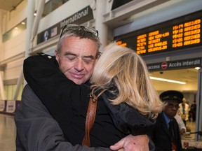 Hector Macmillan gets an emotional hug from his sister Jill Koplowitz at Pearson airport after travelling from Germany where he had surgery to fight his cancer on Thursday, October 27, 2016. (Craig Robertson/Toronto Sun)