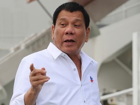 Philippine President Rodrigo Duterte speaks to journalists before getting aboard a coast guard ship at a Japan Coast Guard base in Yokohama, Thursday, Oct. 27, 2016. (AP Photo/Eugene Hoshiko)