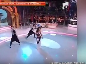 A Romanian pop star’s wardrobe malfunction was caught on live TV. (YouTube screengrab)