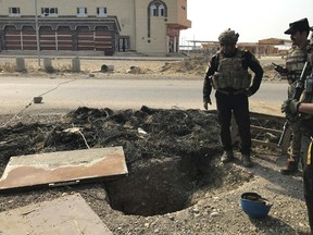 A soldier with Iraq’s elite counterterrorism force inspects a tunnel made by Islamic State militants in Bartella, Iraq, Thursday, Oct. 27, 2016. (AP Photo/Ali Abdul Hassan)