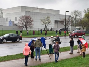 In this April 21, 2016 file photo, people stand outside the entertainer Prince's Paisley Park compound in Chanhassen, Minn. (Jim Gehrz/Star Tribune via AP, File)