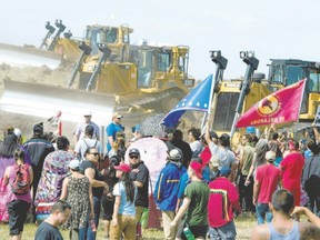 Standing Rock Sioux Tribe members and supporters confront bulldozers working on the Dakota Access pipeline in September. (AFP/Getty Images file photo)