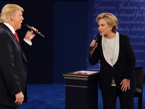 In this Sunday, Oct. 9, 2016, file photo, Republican presidential nominee Donald Trump and Democratic presidential nominee Hillary Clinton speak during the second presidential debate at Washington University in St. Louis.