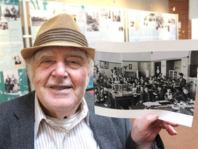 Paul Smits holds up a photo of his school class in Amsterdam from 1936, showing himself at the extreme right and Anne Frank, circled, in the middle. A display about Anne, famous for writing a diary while hiding from the Germans during the Second World War, is currently on at the Kingston Frontenac Public Library’s Central Branch downtown. (Michael Lea/The Whig-Standard)