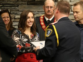 Tim Miller/The Intelligencer
Hastings Quinte Paramedic Chief Doug Socha hands a certificate to Lillian Jolliffe-Czindl at Hastings County Council on Thursday in Belleville. Jolliffe-Czindl was one of several recognized for their life-saving efforts in an incident earlier this month.