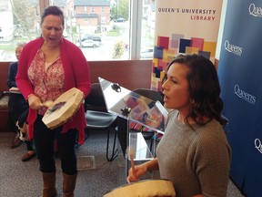 Mary Anne Spencer, left, and Vanessa McCourt of the Four Directions Aboriginal Centre drum at the opening of 12 new indigenously named study rooms at Queen's University's Stauffer Library in Kingston on Oct. 28. (Elliot Ferguson/The Whig-Standard)