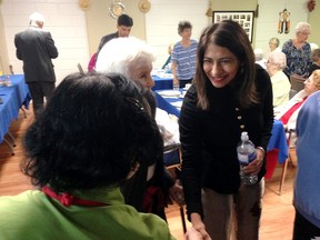 Dipika Damerla, Ontario minister of senior affairs, is welcomed to lunch at the Oasis program at the Bowling Green II apartment building in Kingston on Oct. 28. (Elliot Ferguson/The Whig-Standard)