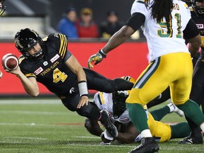 Hamilton Tiger-Cats quarterback Zach Collaros (4) makes a pass while being tackled by Edmonton Eskimos defensive tackle Almondo Sewell (90) during the first-half of CFL football action in Hamilton on Friday, October 28, 2016.