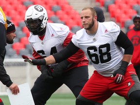 Redblacks offensive linemen Tommie Draheim (right) and J’Micheal Deane at practice. (Jean Levac, Postmedia Network)